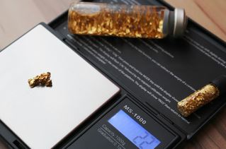 gold pieces being weighed after prospecting